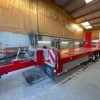 red a&w three axle low loader in shed