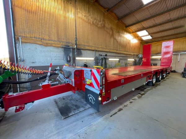 red a&w three axle low loader in shed