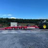 red low loader attached to tractor